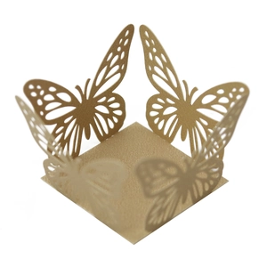 Macro detail of laser-cut gold pearlescent paper candy box with intricate butterfly design