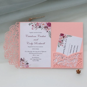Pink laser-cut wedding invitation set with elegant floral patterns and RSVP card