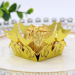 Detail showing golden laser-cut bird design hollow chocolate wrapper for wedding party decor