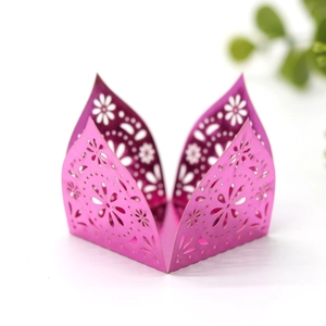 Macro view of laser-cut purple daisy patterns on a mirror-finish candy box decoration