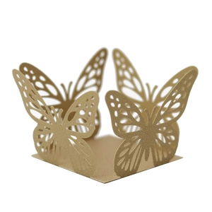 Detail of laser-cut butterfly cupcake wrapper in champagne gold pearlescent paper