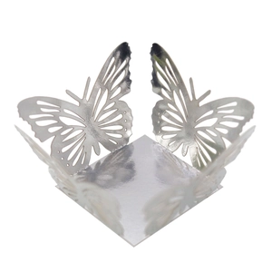 Macro detail of laser-cut silver hollow butterfly wedding favor box with metallic finish