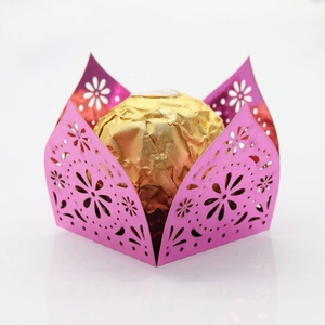 Macro shot of pink laser-cut lace candy box with flower patterns for parties