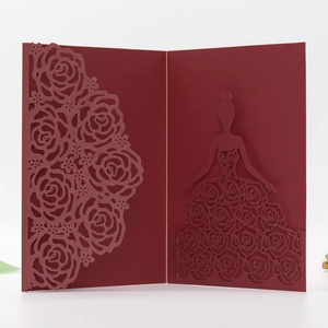 Detailed laser-cut rose patterns and elegant female silhouette on burgundy invitation card