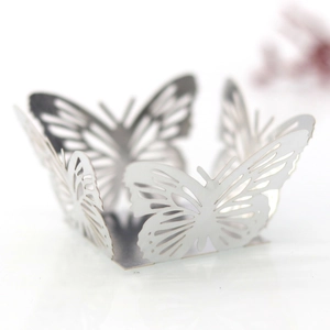 Detailed laser-cut white paper butterfly topper for wedding party cupcake decoration