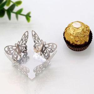 Detail of silver laser-cut butterfly candy box with hollow design for wedding favors