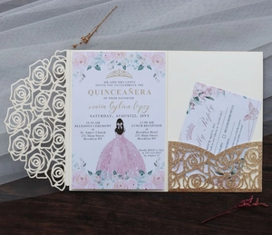 Close-up of glitter gold laser-cut pocket and floral rose wedding invitation suite