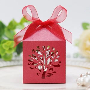 Close-up of red laser-cut tree gift box with elegant organza ribbon and bow detail