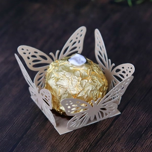 Detailed laser-cut butterfly hollow chocolate wrapper in beige on wood background