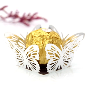 Detail view of white laser-cut butterfly candy box with hollow design for wedding parties