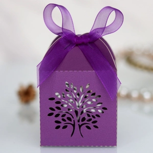 Detailed close-up of purple laser-cut Tree of Life favor box with elegant satin ribbon bow