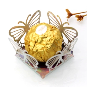 Detail showing a hollow laser-cut butterfly paper wrapper for chocolate candy packaging