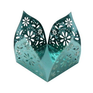 Detail of teal metallic laser-cut hollow petal pattern candy box or cup wrapper