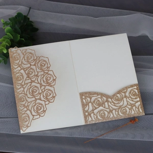 Detail of laser-cut glitter rose invitation card with champagne gold sequins and slot