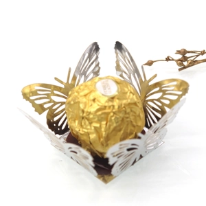 Close-up of laser-cut butterfly hollow chocolate box with metallic texture for parties