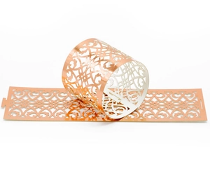 Detailed laser-cut rose gold napkin ring with elegant floral and heart patterns