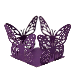 Detailed laser-cut hollow butterfly design on dark purple paper party decoration