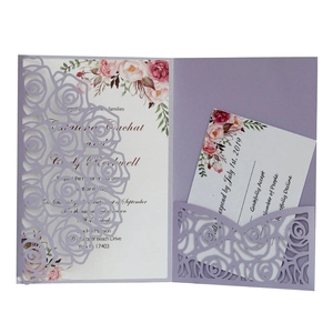 Detail of purple laser-cut rose wedding invitation set with white floral RSVP cards