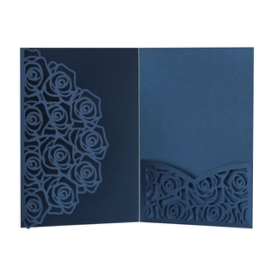 Detailed laser-cut dark blue rose pattern on pearlescent paper wedding invitation