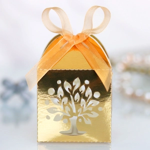 Close-up of golden life tree laser-cut gift box with luxury ribbon and hollow design