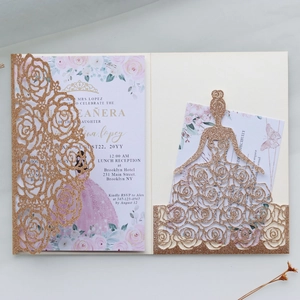 Detail of rose gold glitter laser-cut princess dress invitation with floral inner card