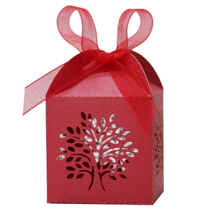 Detailed laser-cut tree of life pattern on red pearl paper candy gift box with ribbon