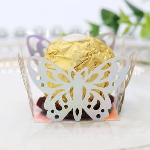 Detailed close-up of a laser-cut pink butterfly paper chocolate wrap for wedding party