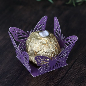 Close-up of laser-cut butterfly candy box in purple paper for party favor decor