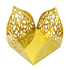 Macro shot of laser-cut gold mirror paper candy box with intricate lace hollow patterns