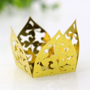 Detail showing laser-cut gold clover cupcake wrappers with elegant metallic finish