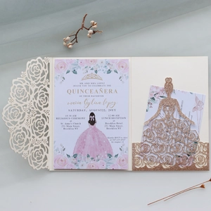 Macro shot of laser-cut rose hollow invitation with glitter princess dress insert