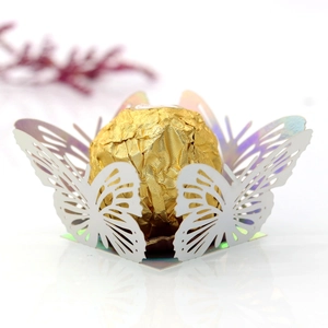 Macro detail of laser-cut butterfly candy box with iridescent finish and hollow design