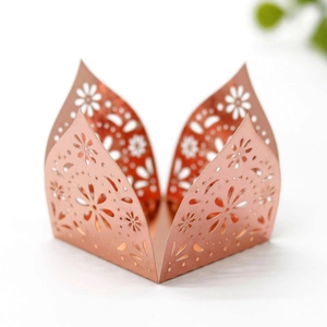 Detailed laser-cut daisy hollow pattern on rose gold cupcake wrappers with metallic finish