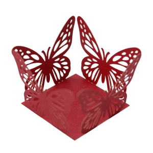 Close-up of red laser-cut butterfly candy box with intricate lace details for party