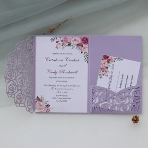 Close-up of laser-cut lavender rose wedding invitation with floral insert and RSVP card