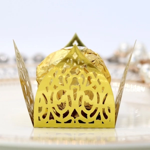 Macro detail of laser-cut gold mirror paper candy wrapper with European vine pattern