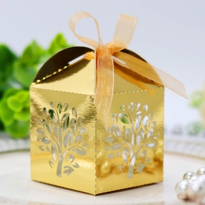 Close-up of laser-cut Tree of Life candy box with elegant orange ribbon bow detail