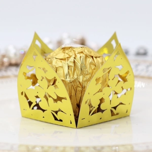 Detailed laser cut gold mirror paper clover candy box with a festive chocolate inside