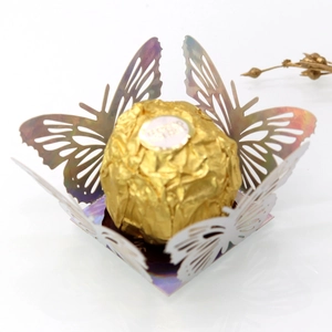 Close-up of laser-cut hollow butterfly paper favor box with an iridescent pearl finish