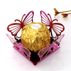 Macro shot of laser-cut butterfly cupcake wrapper in pink purple metallic paper finish