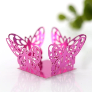 Detail of rose pink laser-cut butterfly decoration in pearlescent paper for party