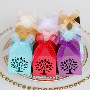 Macro detail of laser-cut tree design on colorful gift boxes with organza ribbons