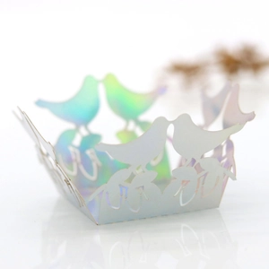 Macro shot of laser-cut iridescent bird design on a wedding favor candy box decoration