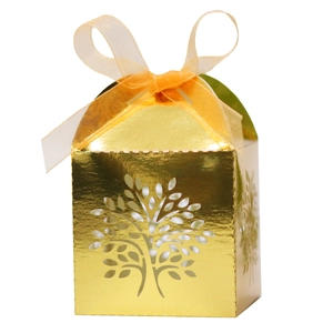 Close-up of golden hollowed tree candy box with an orange satin ribbon bow