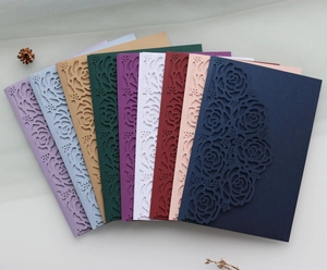 Detailed laser-cut rose patterns on pearlescent paper wedding invitations in multiple colors