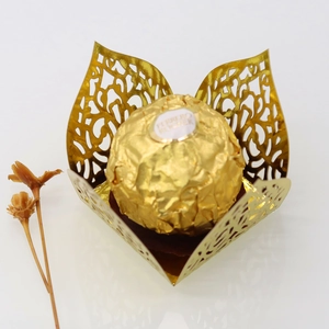 Detail showing golden laser-cut chocolate wrapper with intricate vine patterns