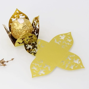 Detailed laser-cut floral pattern on golden candy box with assembled flower shape