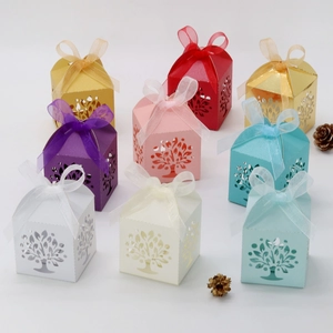 Laser-cut Tree of Life candy boxes in multiple colors with elegant ribbon bows