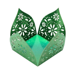 Detail of laser-cut daisy patterns on green metallic pearl paper candy gift box