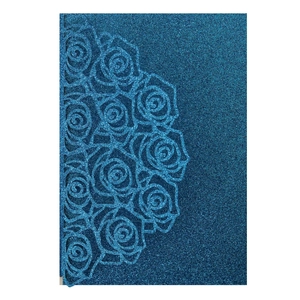 Detail of laser-cut rose patterns on dark blue glitter paper for wedding invitations